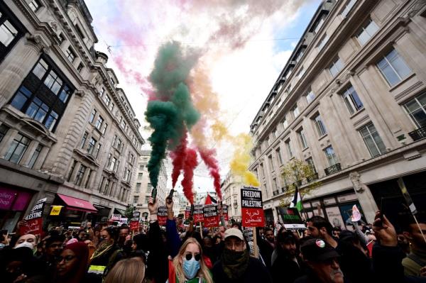 Protesters release flares during a pro-Palestine rally in Regents Street
Pro-Palestine rally,
